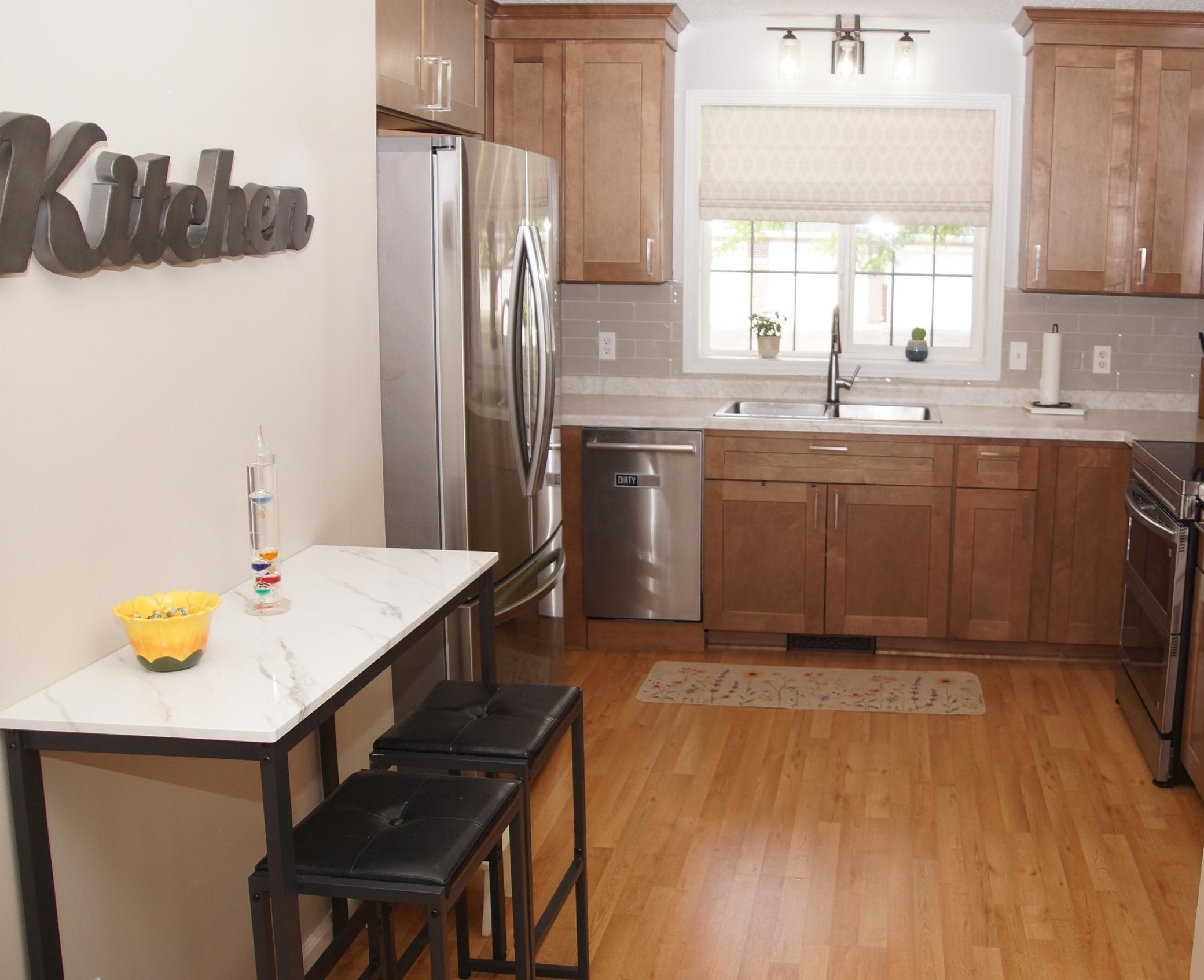 Updated kitchen features new cabinets, stainless steel appliances and newer laminate flooring throughout. All appliances are included, Refrigerator, Double Oven, Dishwasher, Washer, and Dryer, plus a Touch Kitchen Faucet! Making this move-in ready!