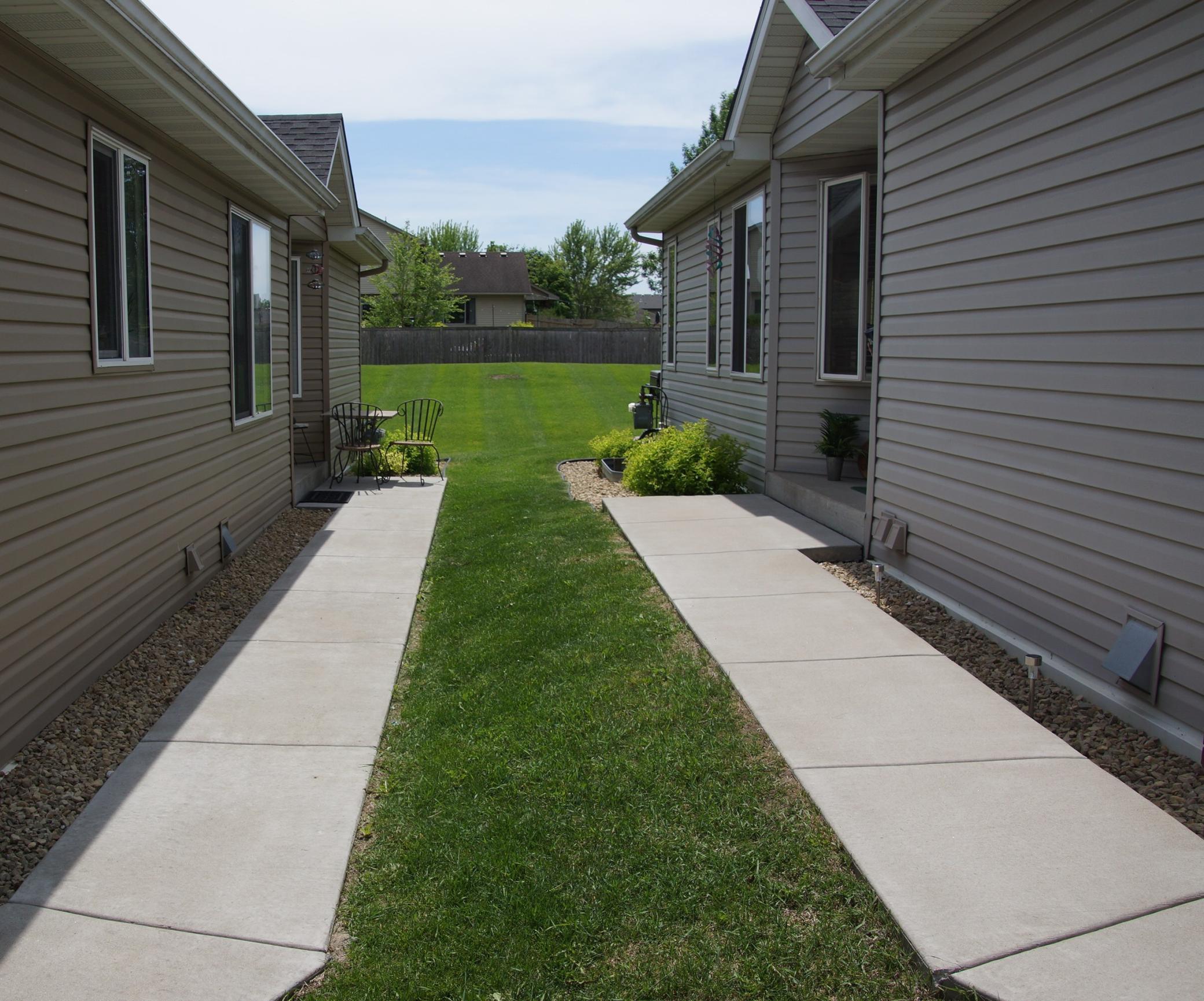 Quit walkway leads to fabulous green space behind townhome!