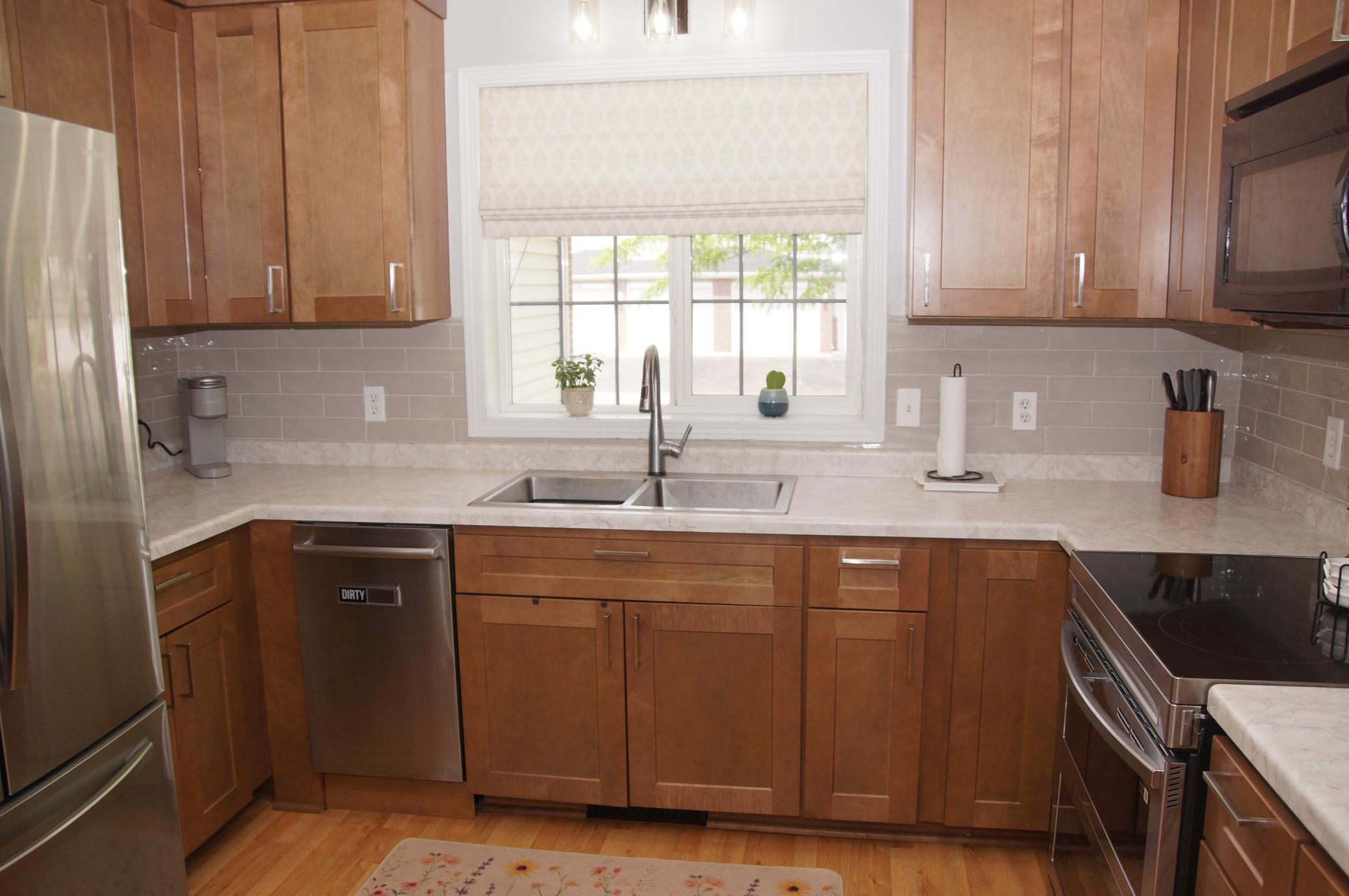 Updated kitchen features new cabinets, stainless steel appliances and newer laminate flooring throughout. All appliances are included, Refrigerator, Double Oven, Dishwasher, Washer, and Dryer, plus a Touch Kitchen Faucet! Making this move-in ready.
