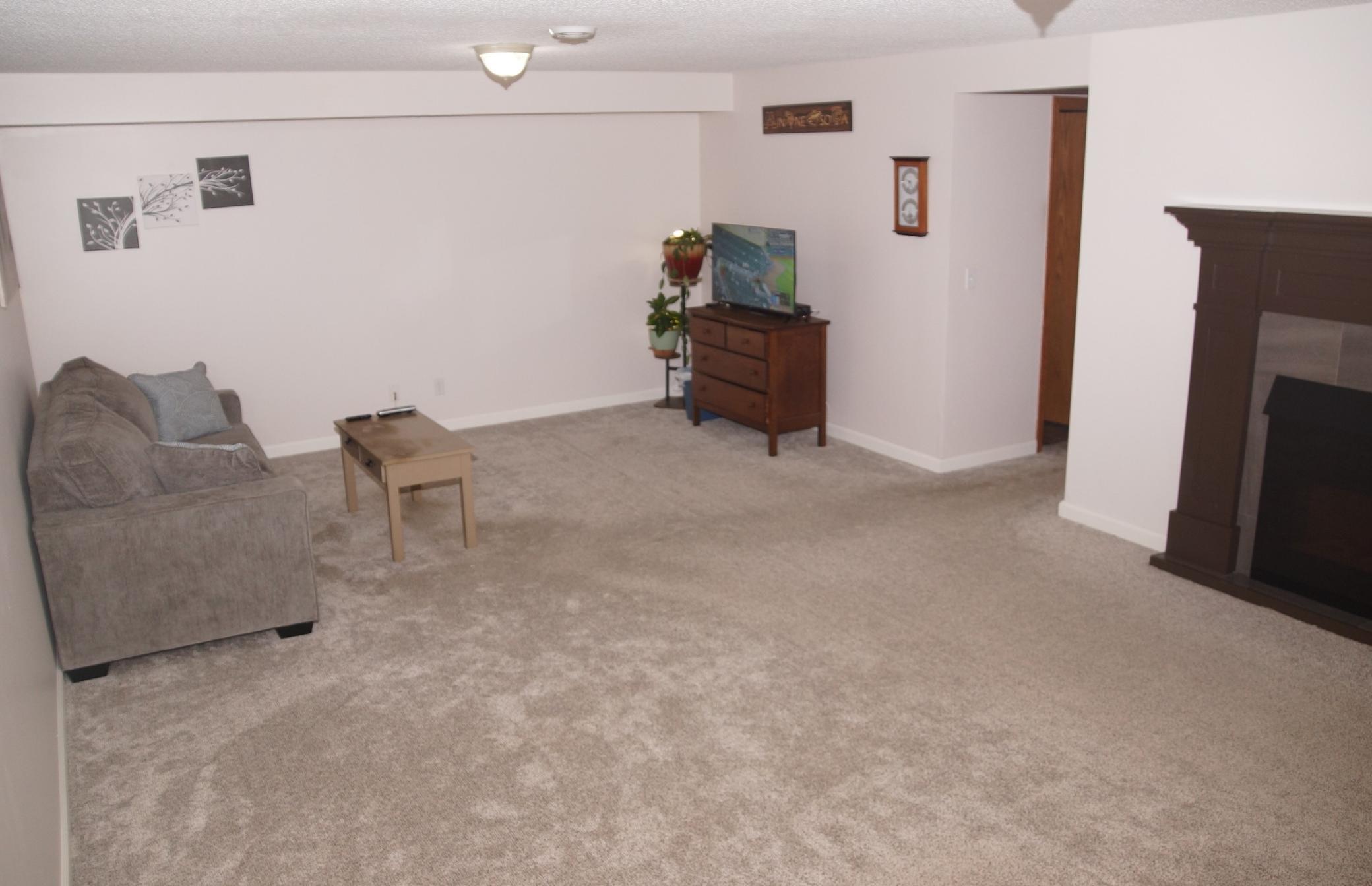 Nice size lower level family room features electric fireplace. Perfect for large sofa and big screen TV!