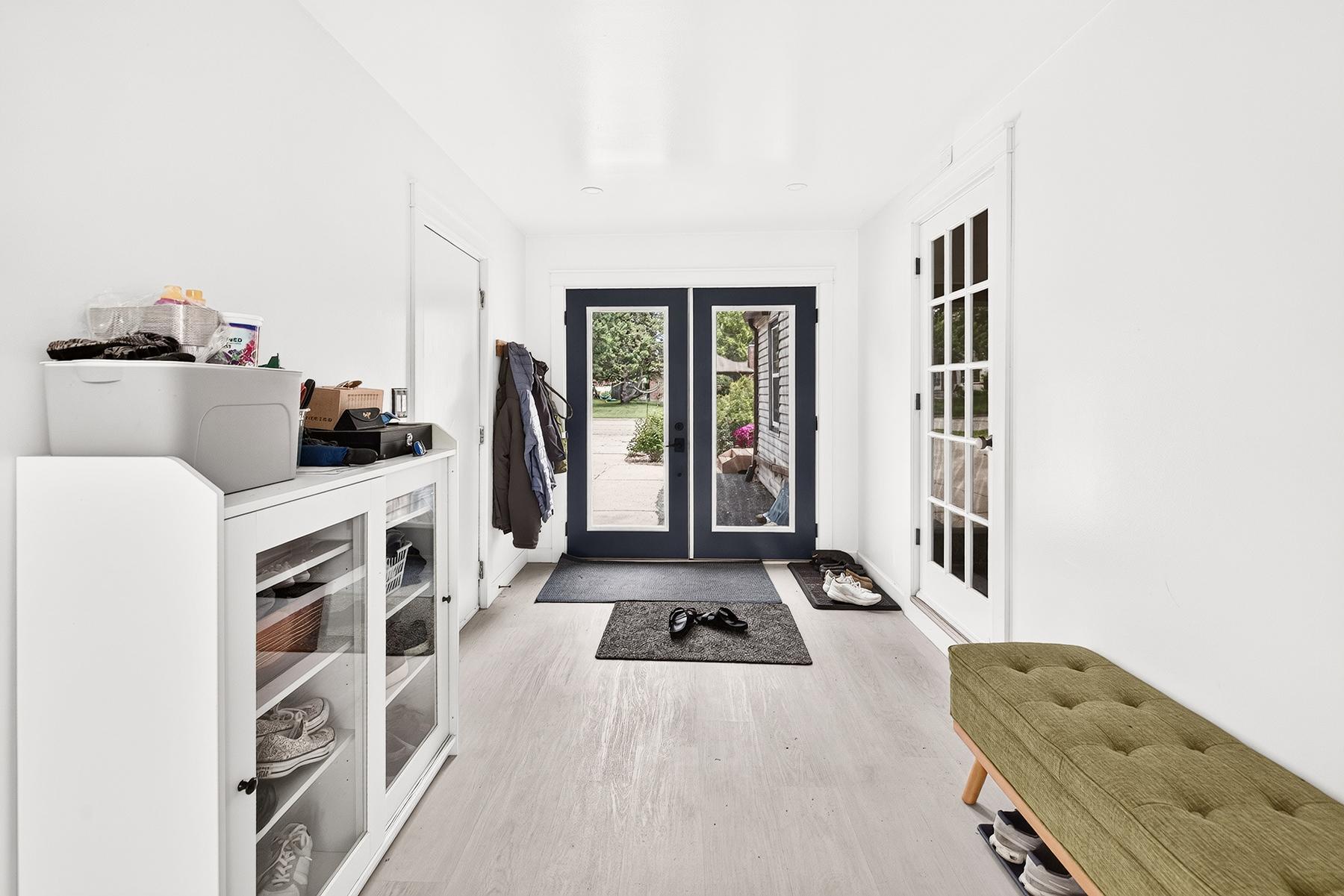 Bright and remodeled breezeway attaches to the garage and offers access out front