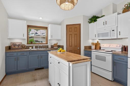 The charming kitchen offers plenty of storage, including a spacious pantry.