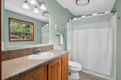 The primary ensuite features a spacious vanity with storage and clean tub/shower combo.