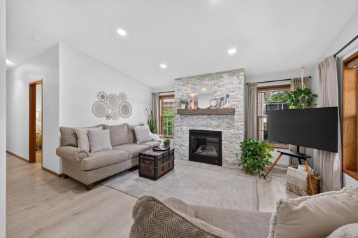The living room is centered around a cozy gas fireplace adding warmth and a charming ambiance.