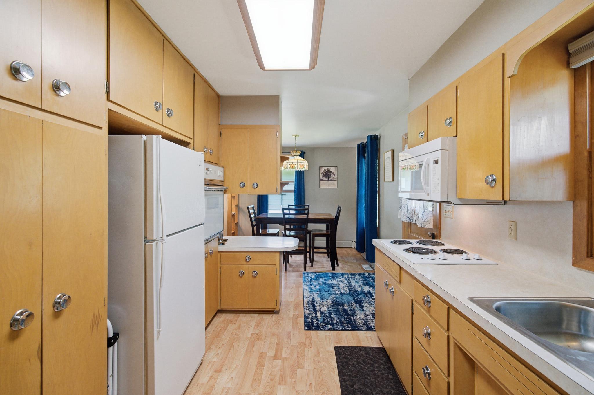 Functional kitchen featuring abundant cabinetry, ample counter space, and a convenient breakfast bar.