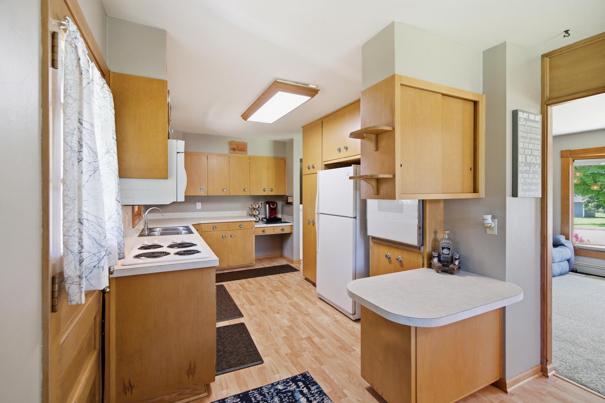 Bright, functional kitchen featuring abundant cabinetry, generous counter-space, and plenty of room for everyday meal preparation.