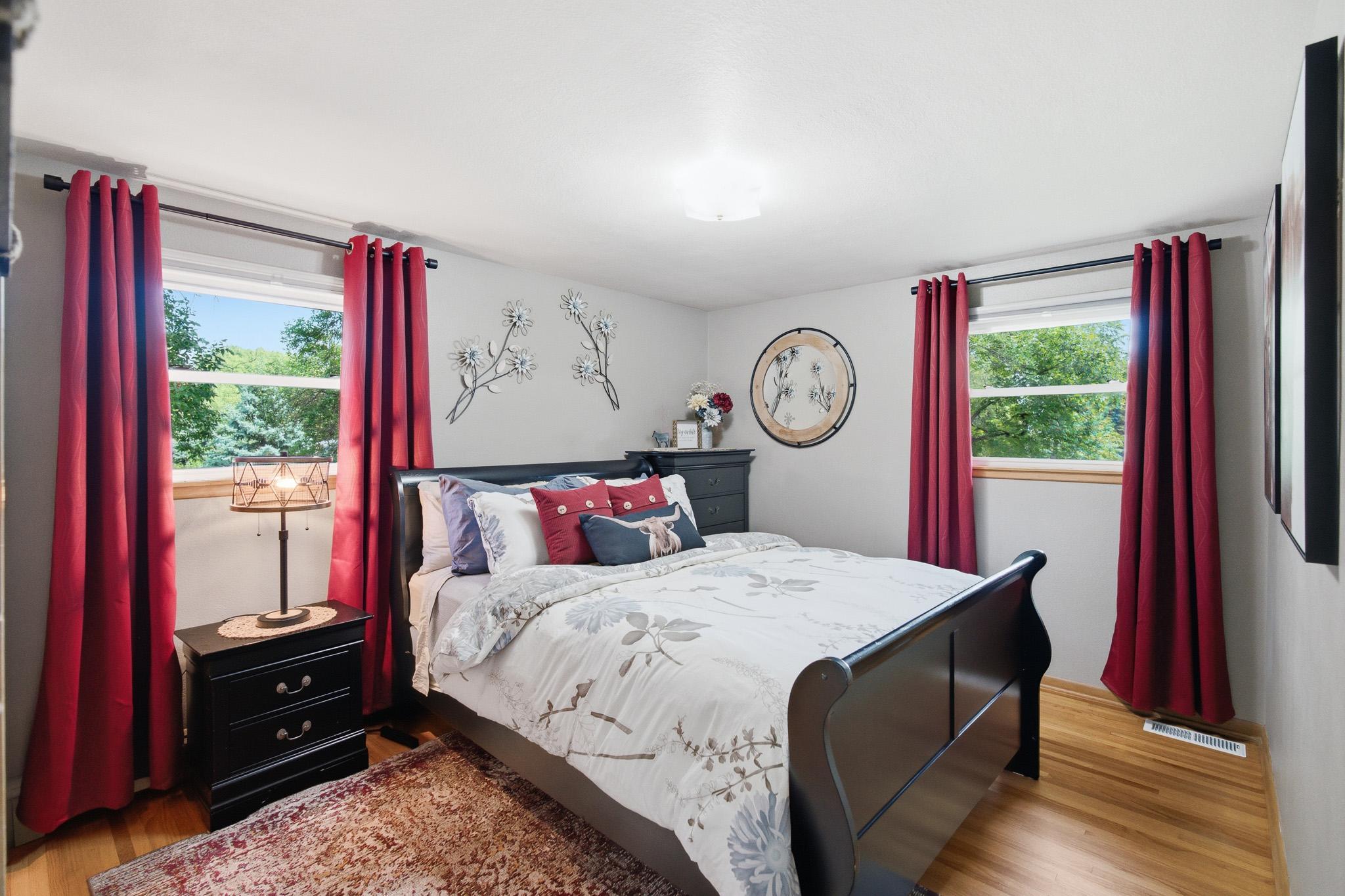 Relax in the bright bedroom with hardwood floors, large windows, and generous space.