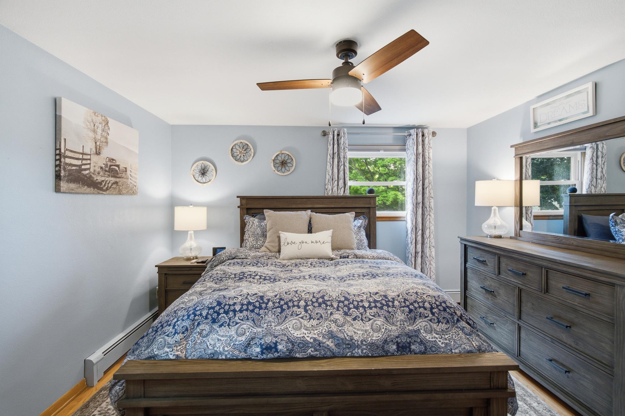 Spacious bedroom featuring beautiful hardwood floors and abundant natural light.
