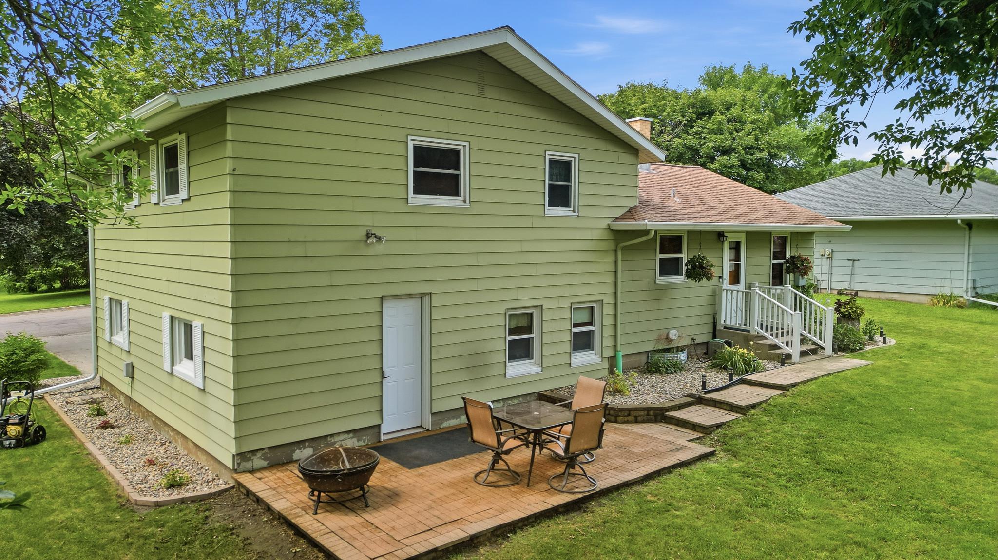 Large backyard with an inviting patio creates the perfect setting for outdoor living.