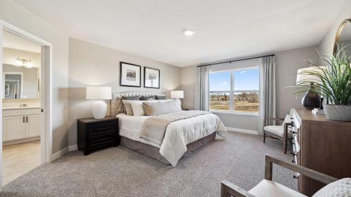 Large primary bedroom has an abundance of space. Photo of model home, color and finishes will vary.