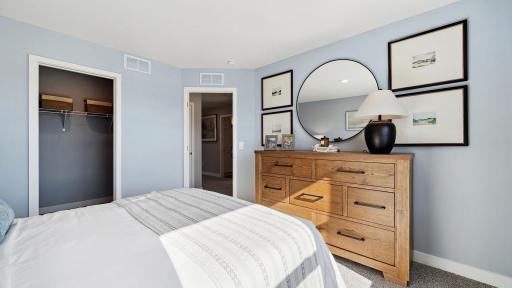 Fourth bedroom upstairs with a walk-in closet. Photo of model, colors and finishes may vary.