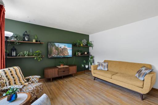 Living room with hardwood floors and stylish accent wall