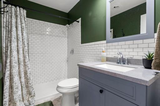 Main level bathroom with tiled shower surround