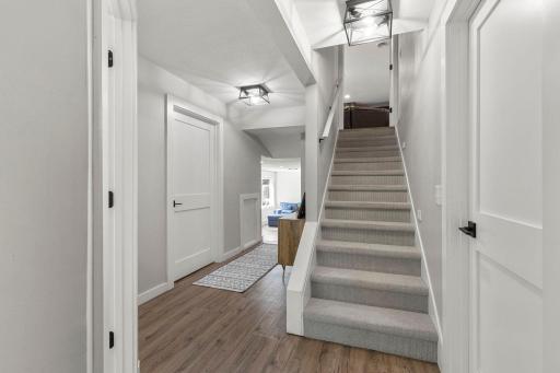 Descend downstairs to the lower level that includes 2 additional bedrooms, a 3/4 bath and spacious family room with bar