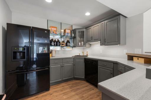 Bar includes a refrigerator, sink and plenty of cabinet space