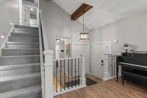 The foyer provides convenient access to both the front entry and attached garage and features a spacious coat closet for added storage