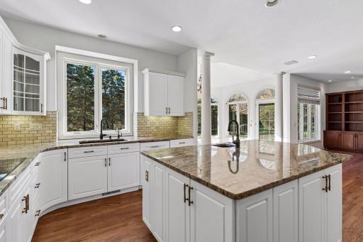 Bright open-concept Kitchen features center island with prep sink & separate Pantry