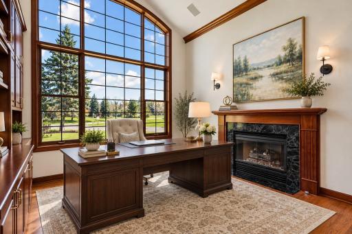 Executive Study with arched window & gas fireplace. Virtually Staged Using AI