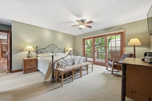 Main bedroom with doors walking out to the deck and lake views