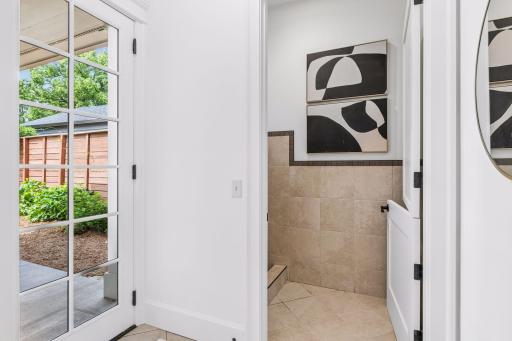 Completing the main floor is a convenient laundry room, mudroom, and dedicated dog wash station.