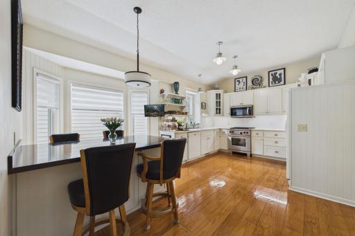 Bright and cheerful kitchen with built in breakfast table. Wolf Range makes you want to try your favorite recipe!