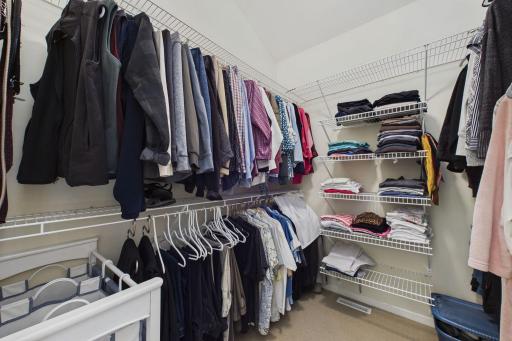 Walk in closet with organizers to keep clothes neat and tidy.