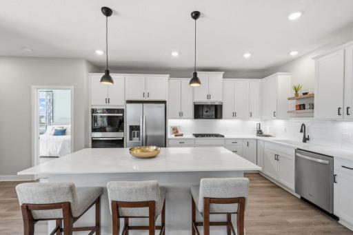 Rightsizing or downsizing doesn't mean you have to give up a great kitchen! Your kitchen will include a gas range and cabinets in place of the built-in ovens and beautiful quartz countertops. Photo of model home finishes may vary.