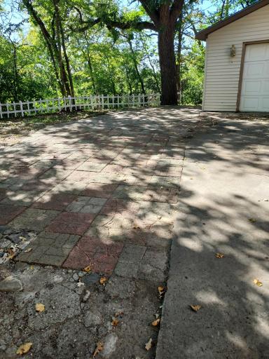 Patio blocks right next to driveway make for a super large driveway / parking spaces.