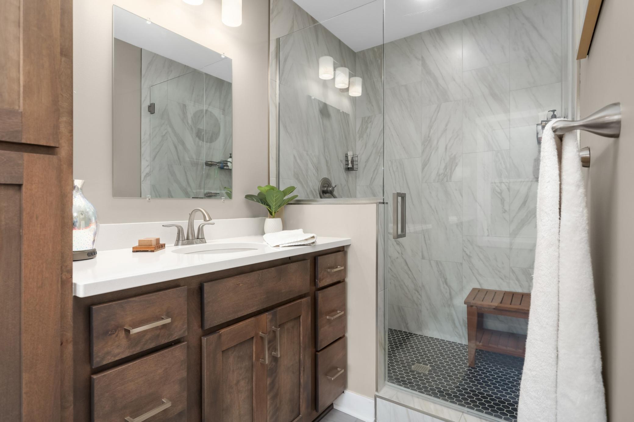 Floor-to-ceiling tiled shower creates a polished, spa-inspired feel
