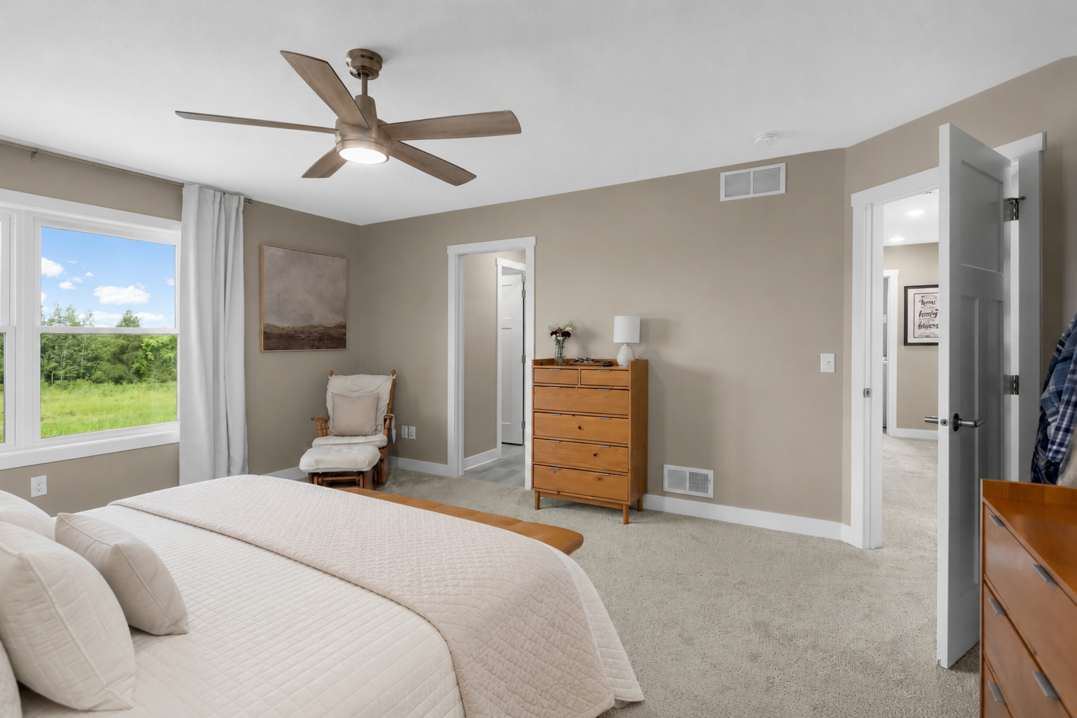 Spacious primary bedroom offers a comfortable and private retreat, with private bathroom and walk-in closet