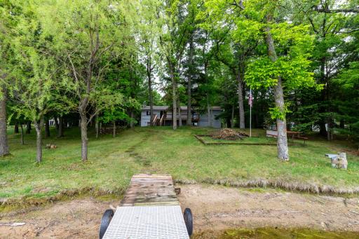 A view of the home from your dock. Note the nice fire pit area for campfires by the lake!