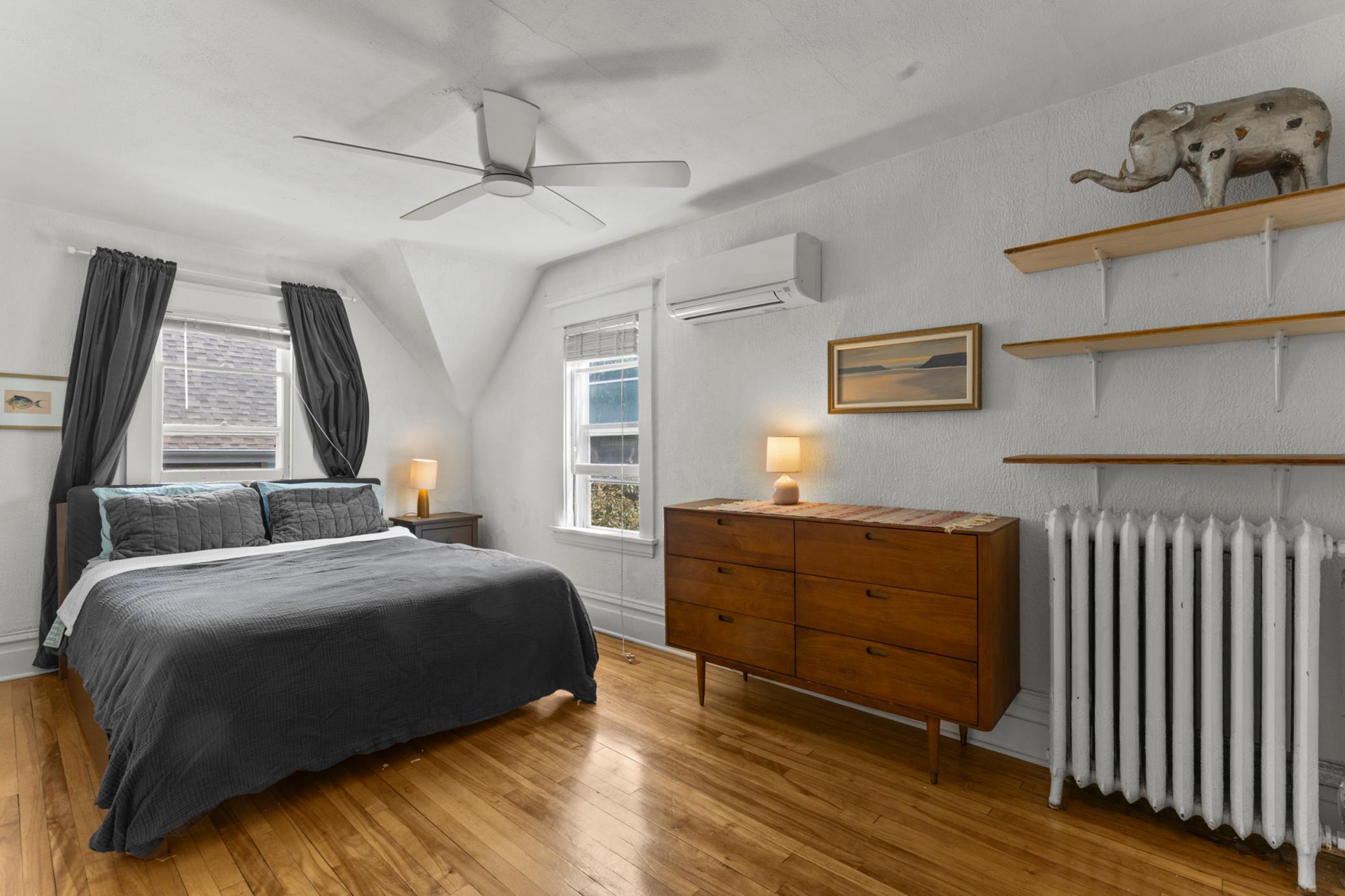 Primary bedroom with beautiful floors, ceiling fan & mini split.