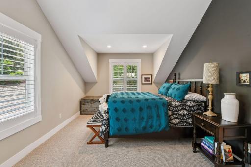 Bedroom 2- all of the upper level bedrooms are charming thanks to the custom architecture
