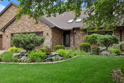 Outstanding curb appeal with a paver driveway approach. Beautiful and thoughtful landscaping envelope this home~