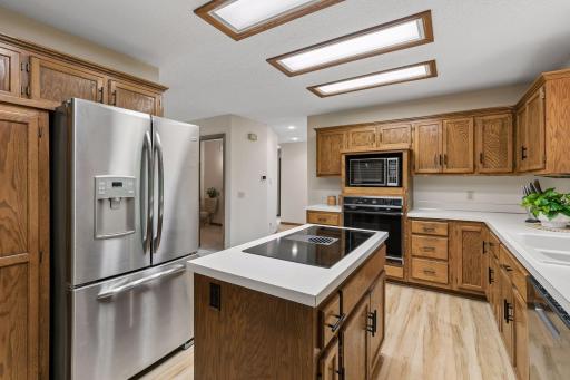 Half bath centrally located. Hallway leads to garage entry, laundry as well as the family room, office and four season porch. So much to see!