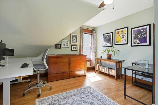 Second upper level bedroom, currently used as a shared office space.