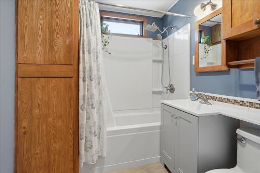 Upper level full bath has been refreshed with new flooring, vanity & light fixture. Convenient storage closet within the bathroom.