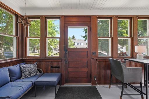 The classic front porch has a nice combination of original woodwork & fresh paint.