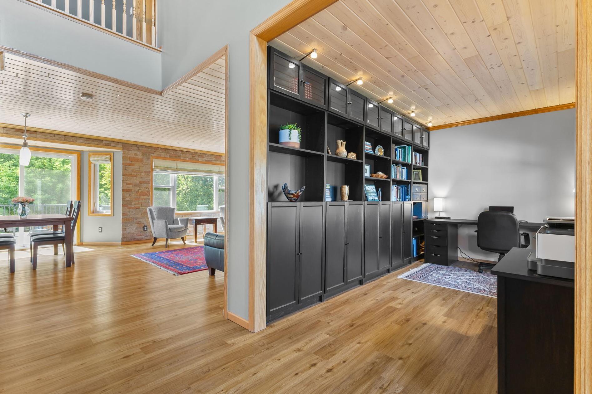Upon entry, you'll be welcomed by a spacious entryway, grand stairway stretching to the upper level, and views of the mature rear yard trees.