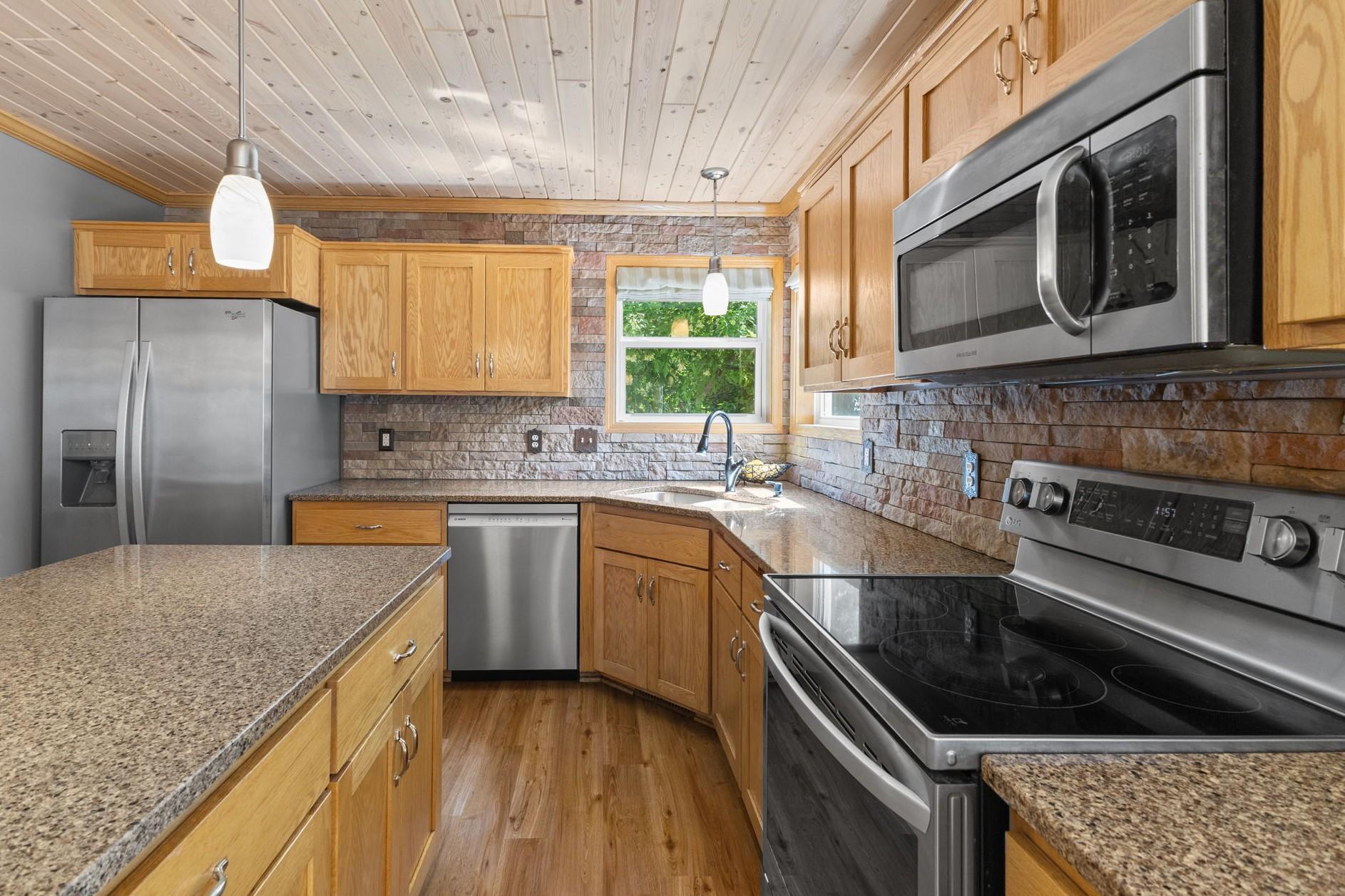The kitchen features stainless steel appliances and stunning quartz countertops.