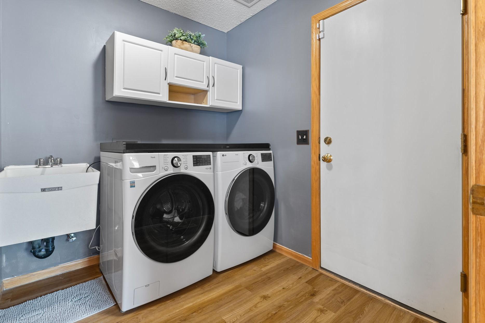 A designated laundry room with sink is located directly inside the entry from the 3-stall garage.