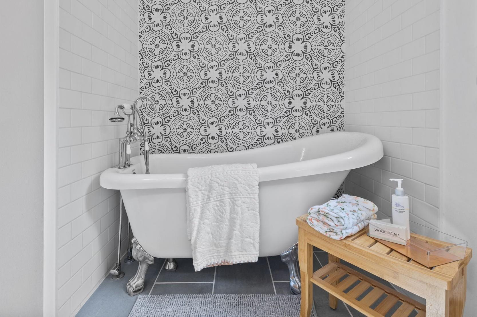 This charming full bathroom on the upper level exudes relaxation goals.