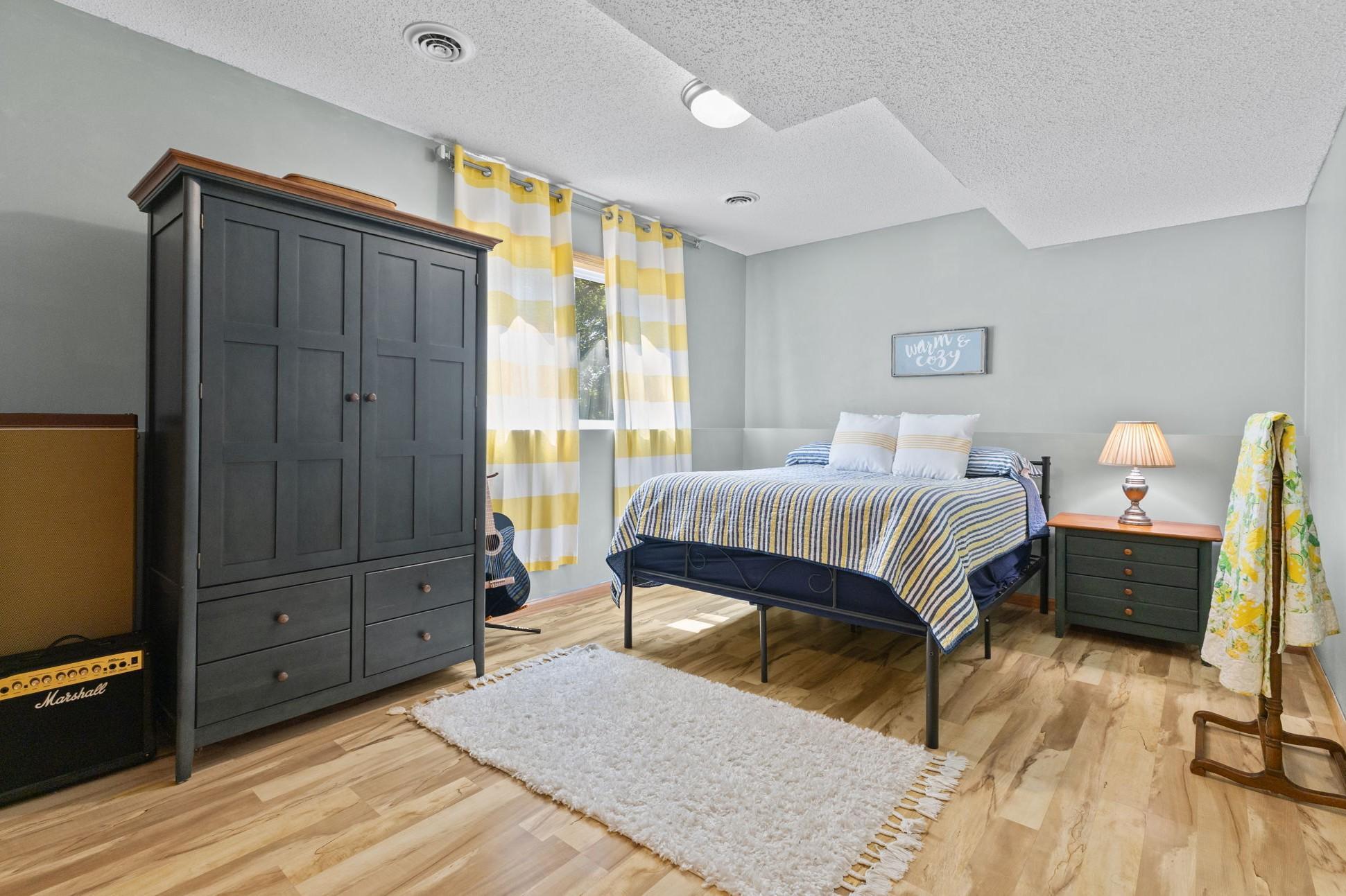 This lower level bedroom features a window facing the back yard.