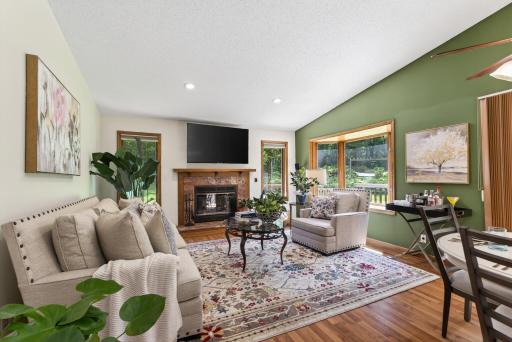 Beautiful, large living room with wood burning fireplace and pink granite surround
