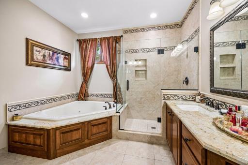 Stunning Primary Bathroom - Separate Stone Tile Walk-in Shower and Large Corner Jetted Bathtub