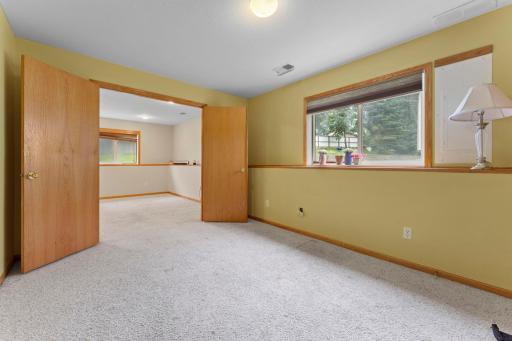Double doors for secondary bedroom with lookout window. Freshly cleaned carpet and spacious area with nook for desk, dresser, etc.