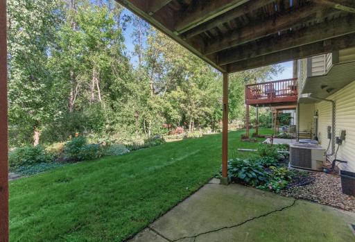 Lower-level walkout opens to a peaceful backyard setting.