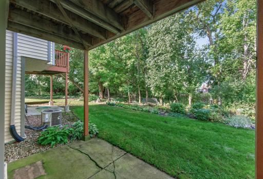 Lower-level walkout opens to a peaceful backyard setting.