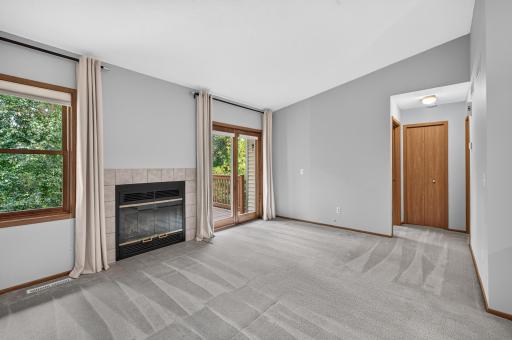 Inviting living room with fireplace and walkout to the deck.