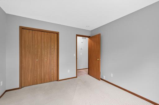Upper-level secondary bedroom with convenient closet storage.